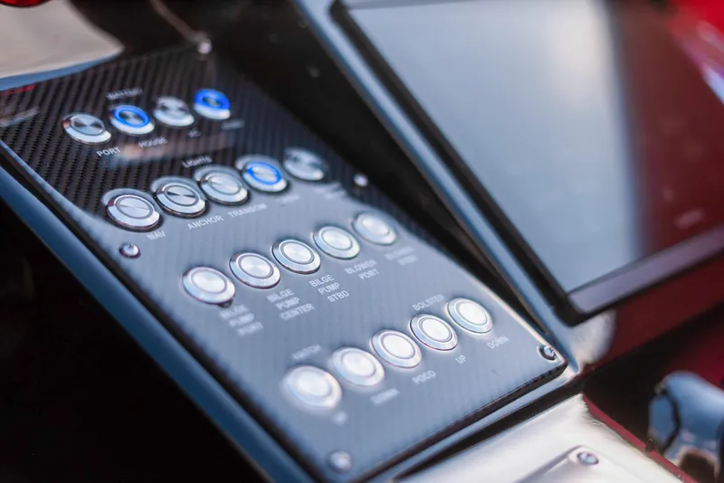 Slide: The Image of Control panel of 2025 Cigarette 42X boat with carbon fiber finish and modern buttons. - 28