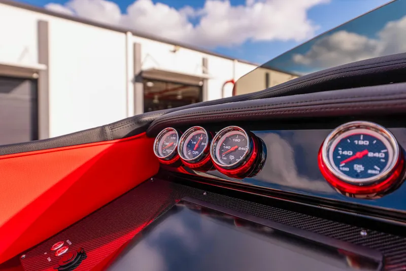Slide: The Image of Close-up of 2025 Cigarette 42X dashboard with gauges and red accents. - 31