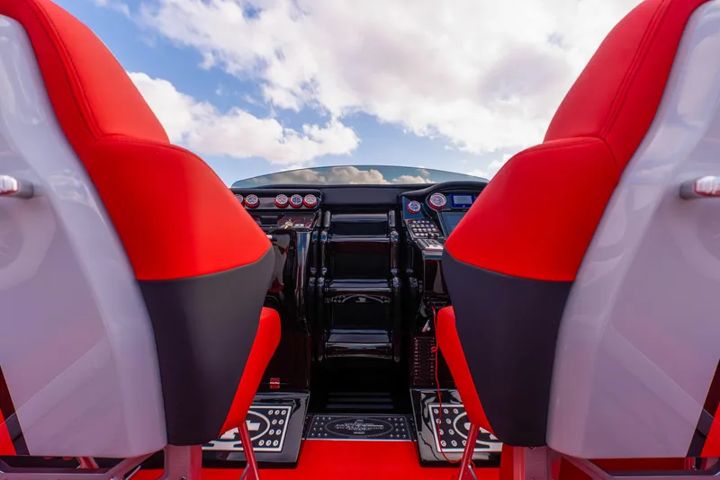 Slide: The Image of Cockpit of 2025 Cigarette 42X boat with red and black seats, dashboard, and controls. - 32