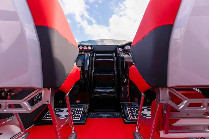 Slide: The Image of Cockpit of 2025 Cigarette 42X powerboat with red and black seats. - 33