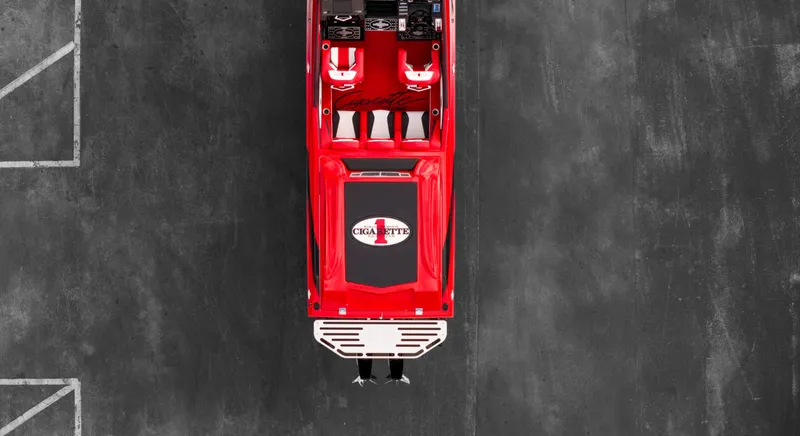 Slide: The Image of Top view of a red 2025 Cigarette 42X speedboat on a concrete surface. - 34