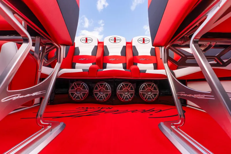 Slide: The Image of 2025 Cigarette 42X boat interior with red and white seats and custom audio system. - 36