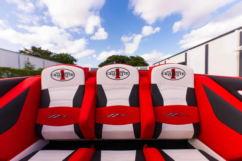 Slide: The Image of Cigarette 42X 2025 boat interior with red and white seats under a blue sky. - 38