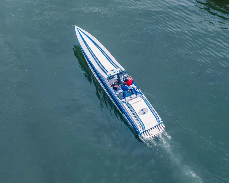 Slide: The Image of 2025 Cigarette 42X speedboat cruising on water, aerial view. - 4