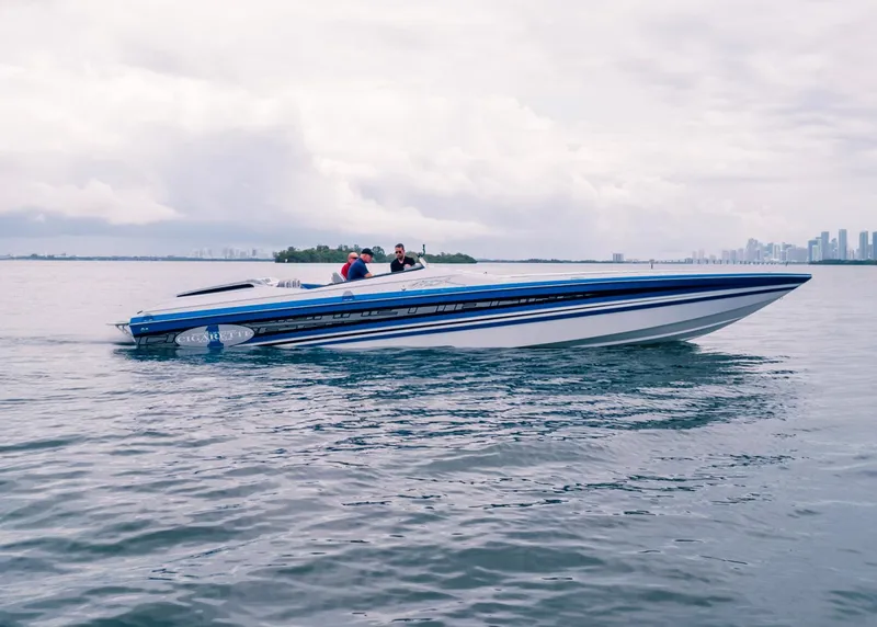 Slide: The Image of 2025 Cigarette 42X speedboat cruising on calm waters with city skyline in the background. - 7