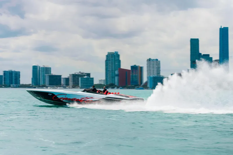 Slide: The Image of 2025 Cigarette 515 speedboat racing on water with city skyline in the background. - 10