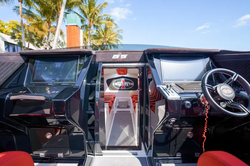 Slide: The Image of 2025 Cigarette 515 boat dashboard with advanced navigation systems and steering wheel. - 12