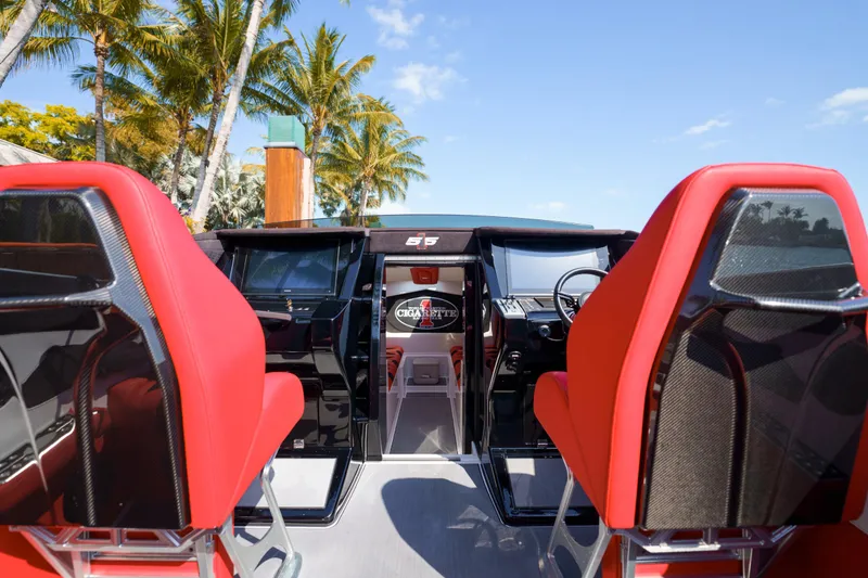Slide: The Image of Cigarette 515 boat interior with red seats, modern dashboard, and tropical background. - 13