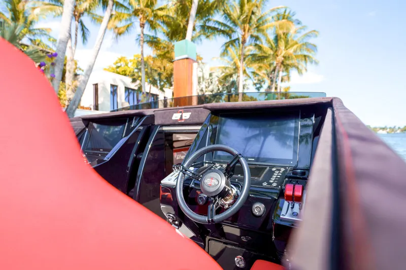 Slide: The Image of 2025 Cigarette 515 boat interior with red seats and modern dashboard. - 14