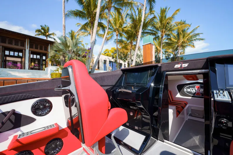Slide: The Image of 2025 Cigarette 515 boat interior with red and black seats, palm trees in background. - 16