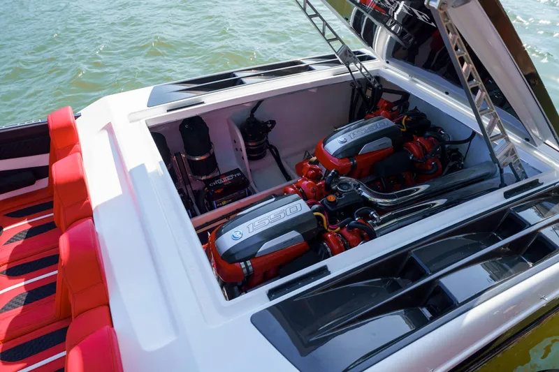 Slide: The Image of 2025 Cigarette 515 boat engine compartment with twin engines and red seating. - 18