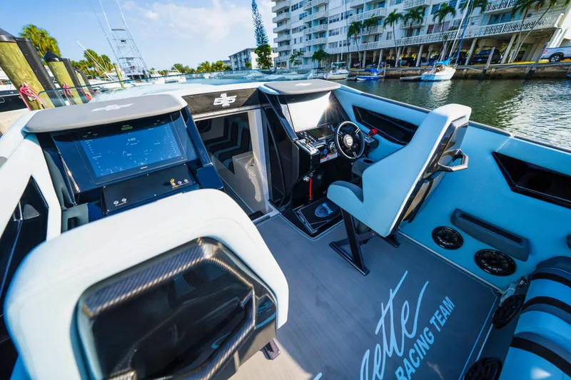 Slide: The Image of Interior of 2025 Cigarette 515 boat with modern dashboard and steering wheel. - 31