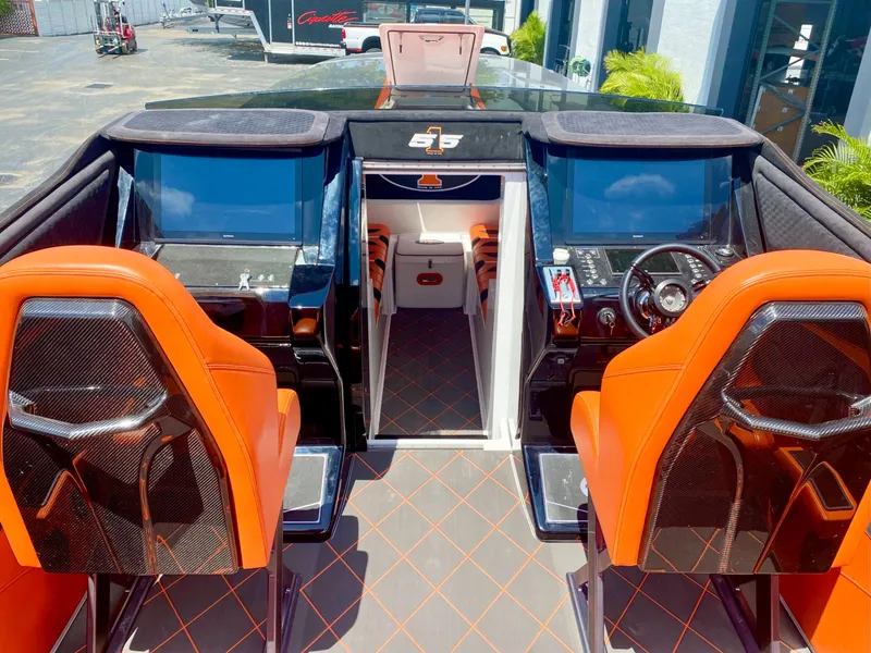 Slide: The Image of 2025 Cigarette 515 boat interior with orange seats and advanced control panels. - 34