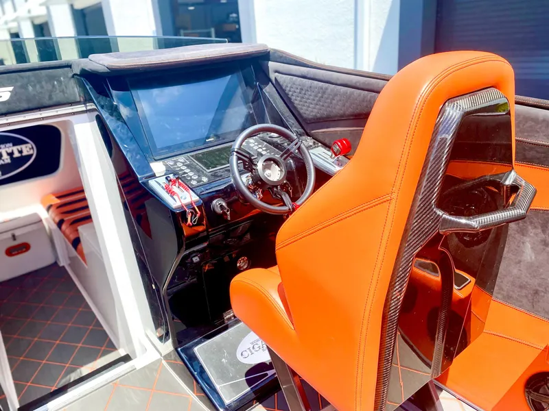 Slide: The Image of 2025 Cigarette 515 boat cockpit with orange seat and advanced control panel. - 36