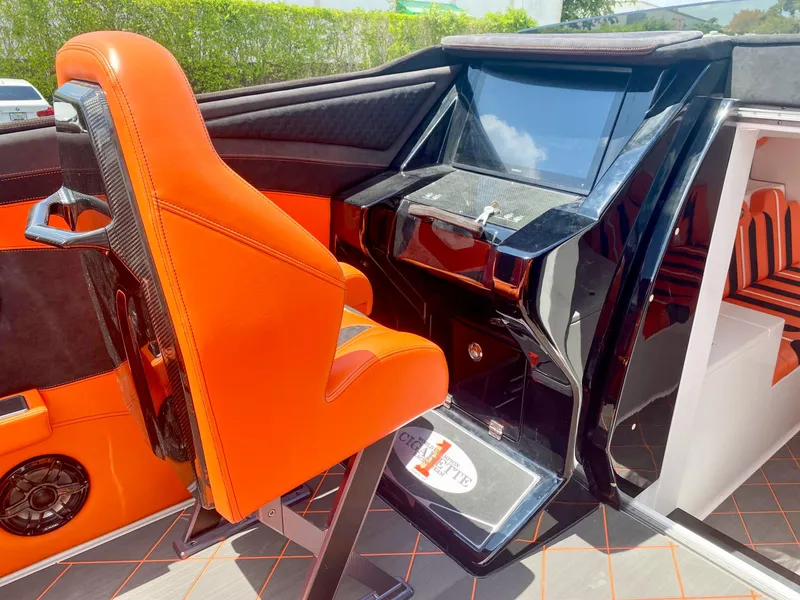 Slide: The Image of 2025 Cigarette 515 boat interior with orange seats and modern dashboard. - 37