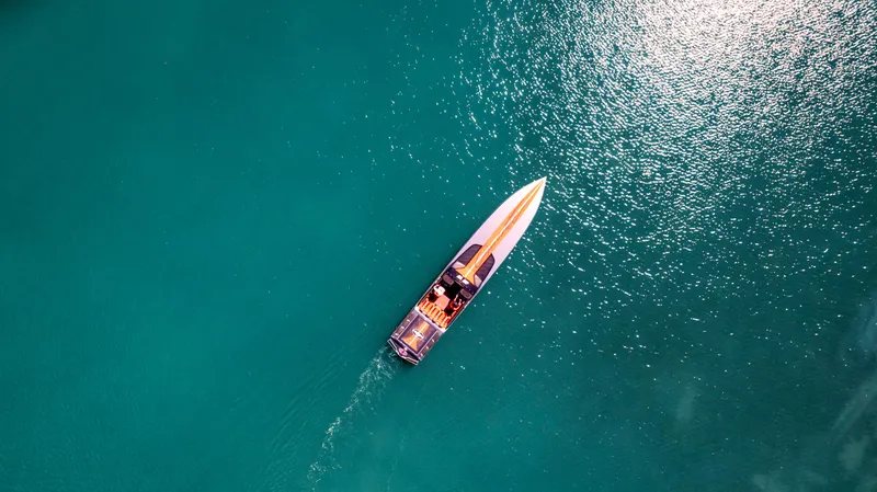 Slide: The Image of Aerial view of 2025 Cigarette 515 boat cruising on clear turquoise water. - 41