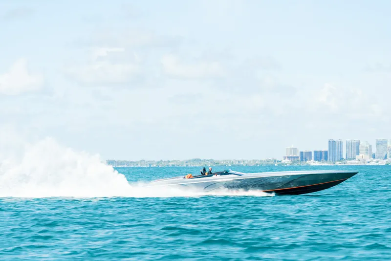 Slide: The Image of 2025 Cigarette 515 speedboat racing on blue ocean near city skyline. - 42
