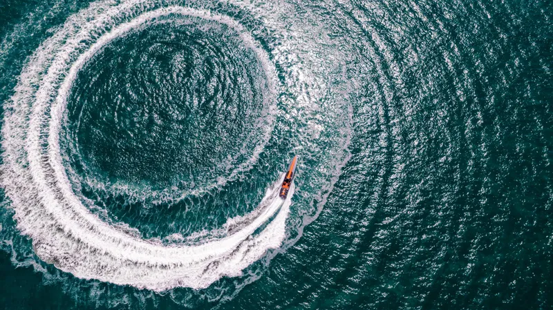 Slide: The Image of Aerial view of Cigarette 515 boat making a circular wake in the ocean, 2025 model. - 43