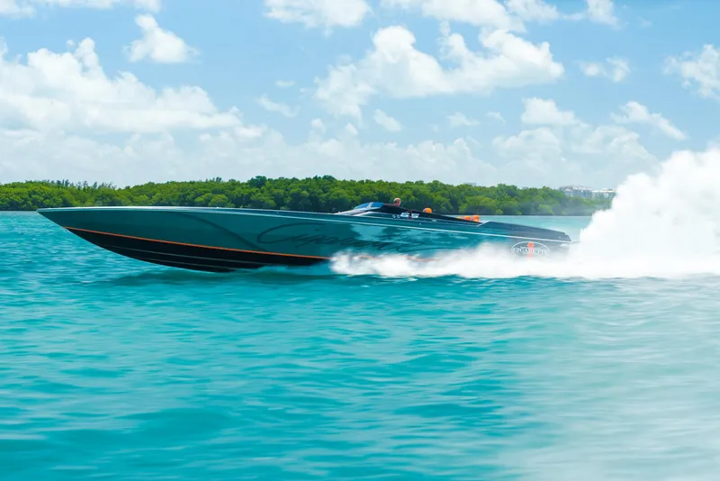 Slide: The Image of 2025 Cigarette 515 speedboat racing on turquoise water under a clear sky. - 46