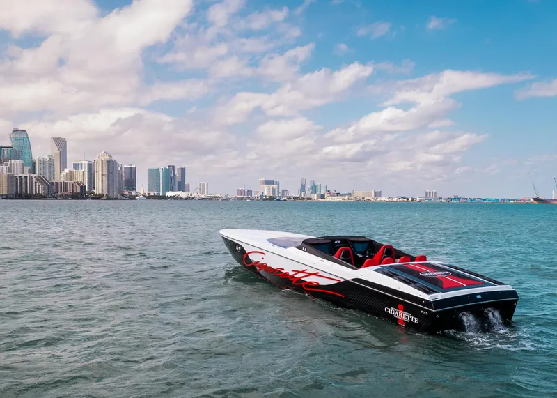 Slide: The Image of Cigarette 515 speedboat cruising near a city skyline, 2025 model. - 48