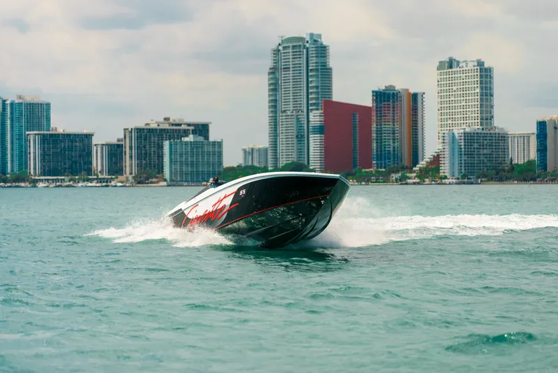 Slide: The Image of Cigarette 515 speedboat cruising near city skyline, 2025 model. - 9
