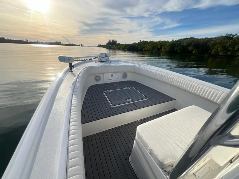 Slide: The Image of 2024 Deno 2400 CC boat on calm water at sunset. - 3