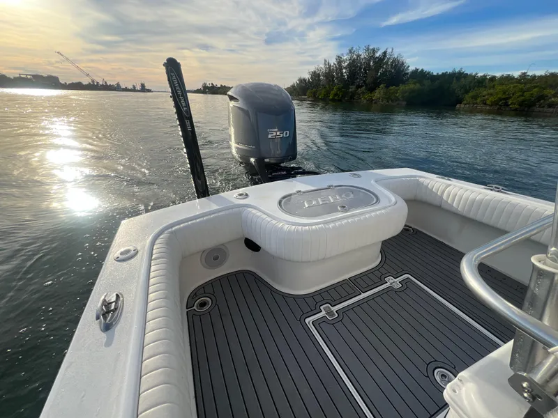 Slide: The Image of 2024 Deno 2400 CC boat with 250 HP engine on calm water at sunset. - 5