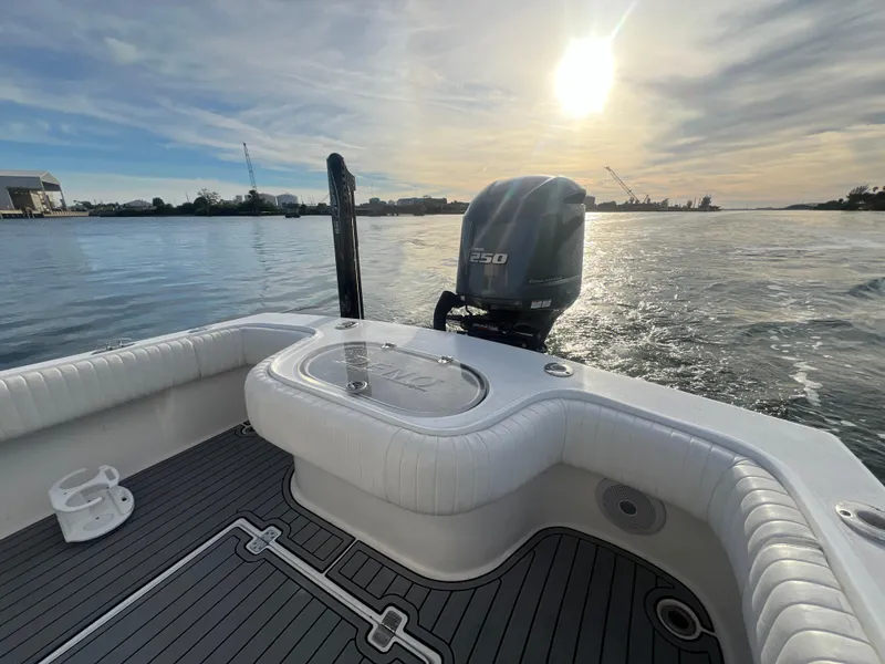 Slide: The Image of 2024 Deno 2400 CC boat with 250 HP engine on calm water at sunset. - 6