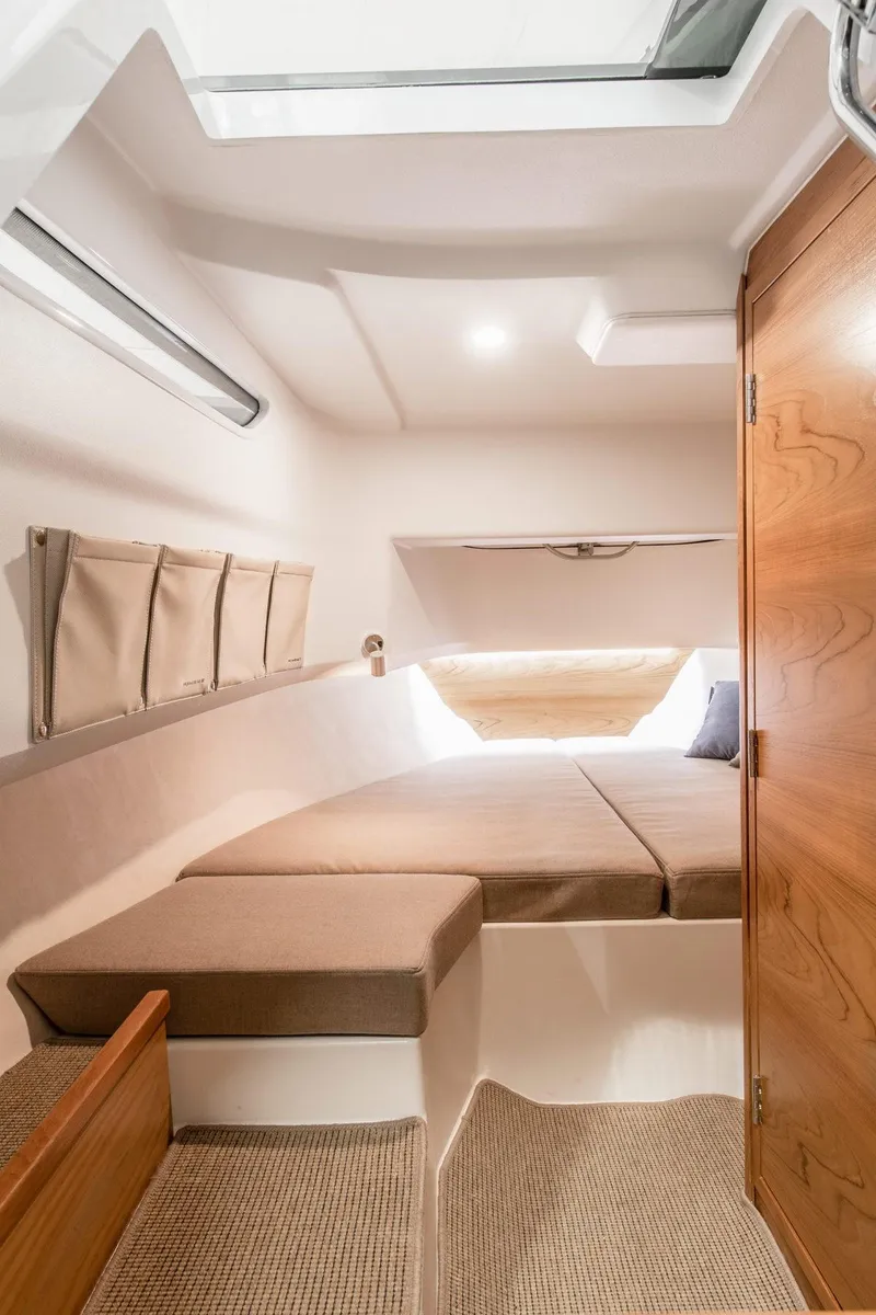 Slide: The Image of Cozy cabin interior of the 2024 Nimbus T9 boat with modern furnishings. - 3
