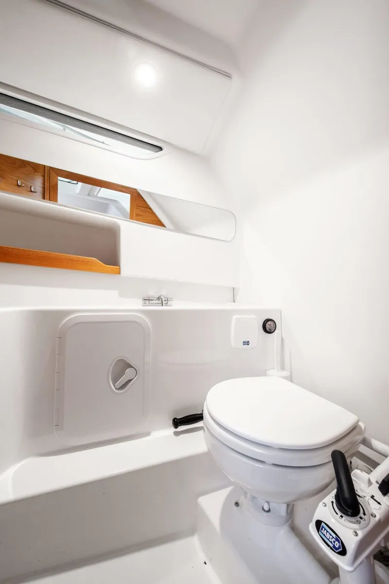 Slide: The Image of Modern bathroom in 2024 Nimbus T9 boat with white fixtures and mirror. - 4