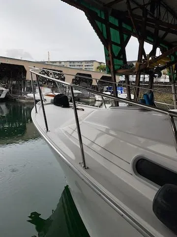 Slide: The Image of 1992 Bayliner 3288 Motoryacht docked in a marina. - 1