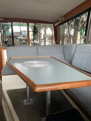Slide: The Image of Interior of 1992 Bayliner 3288 Motoryacht with dining table and gray seating. - 15