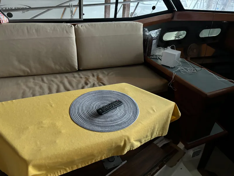 Slide: The Image of Interior of 1992 Bayliner 3288 Motoryacht with beige seating and yellow tablecloth. - 18