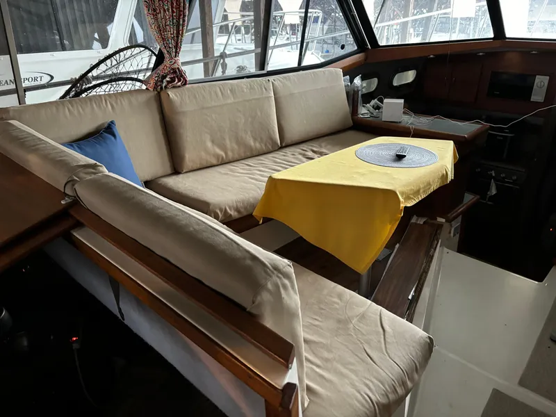 Slide: The Image of Interior of 1992 Bayliner 3288 Motoryacht with beige seating and yellow tablecloth. - 19