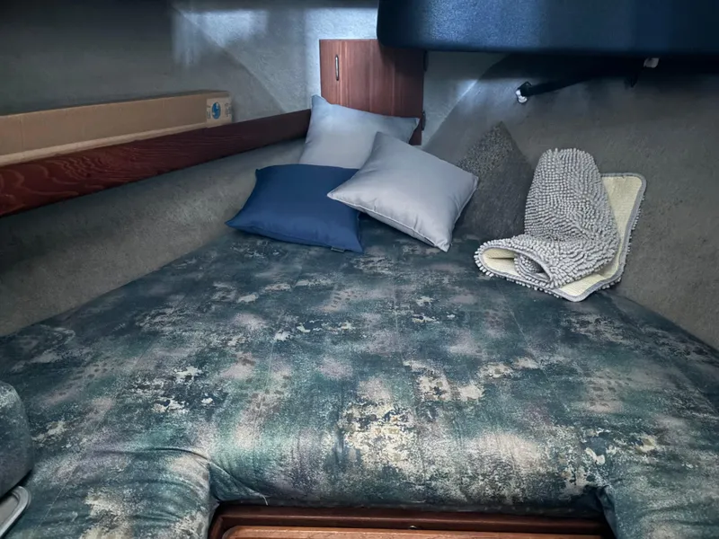Slide: The Image of 1992 Bayliner 3288 Motoryacht cabin with bed, pillows, and blanket. - 28