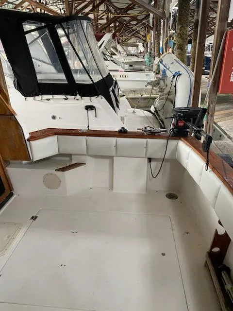 Slide: The Image of 1992 Bayliner 3288 Motoryacht docked, showing spacious cockpit area. - 7