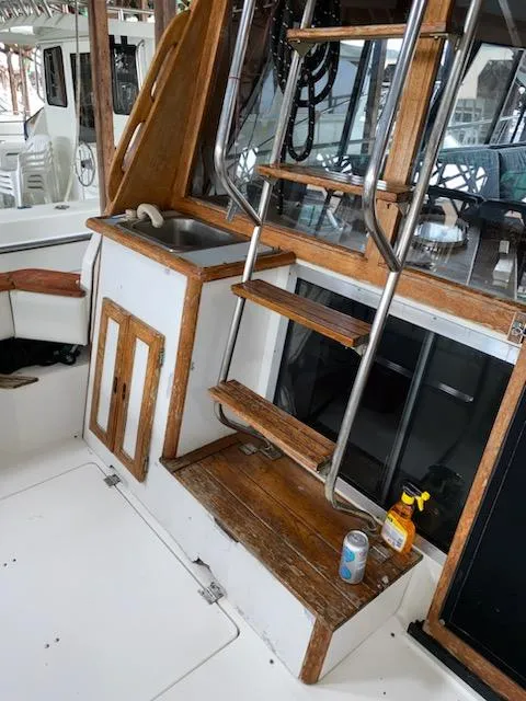 Slide: The Image of 1992 Bayliner 3288 Motoryacht interior with wooden stairs and small sink. - 8