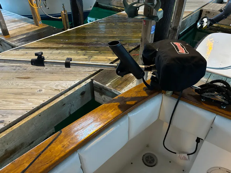 Slide: The Image of Bayliner 3288 Motoryacht 1992 docked, showing fishing rod holder and boat deck details. - 9