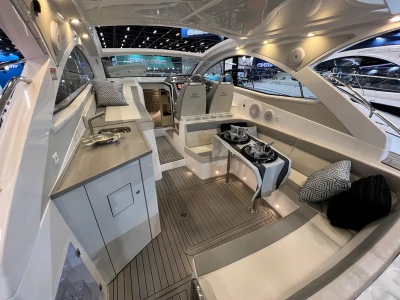 Slide: The Image of 2024 Evolve 360HT luxury yacht interior with modern seating, dining area, and sleek design. - 10