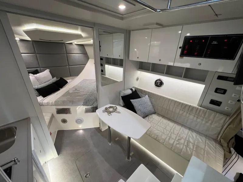 Slide: The Image of 2024 Evolve 360HT interior with modern design, cozy bed, and seating area. - 16
