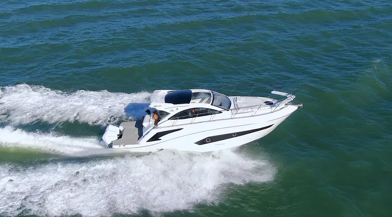 Slide: The Image of 2024 Evolve 360HT luxury motor yacht cruising on open water. - 2