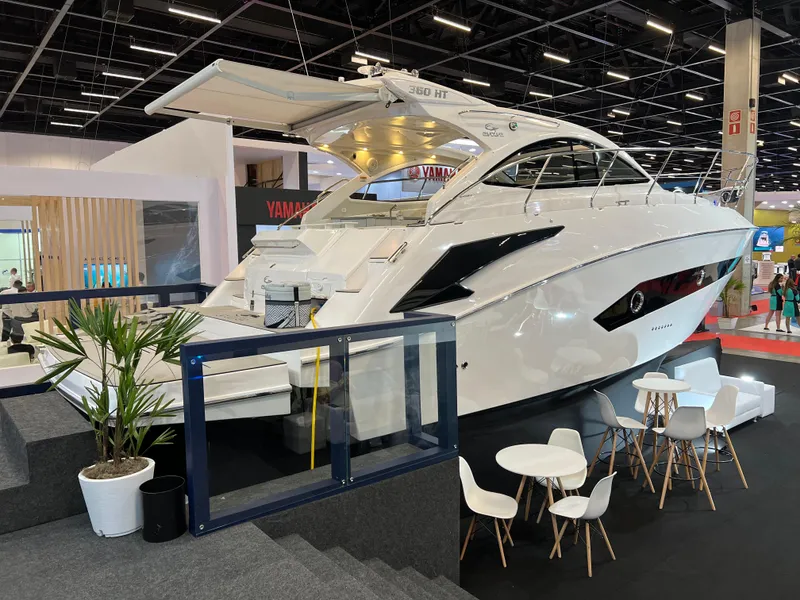 Slide: The Image of 2024 Evolve 360HT luxury yacht on display at a boat show. - 5