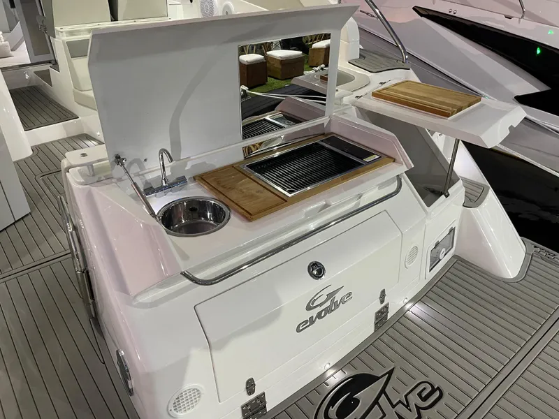Slide: The Image of 2024 Evolve 360HT boat with outdoor kitchen and sink. - 6