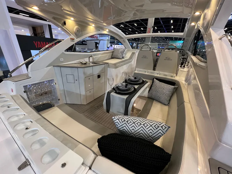 Slide: The Image of 2024 Evolve 360HT luxury yacht interior with modern seating and entertainment area. - 7