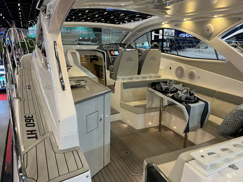 Slide: The Image of 2024 Evolve 360HT luxury yacht interior with modern seating and dining area. - 9