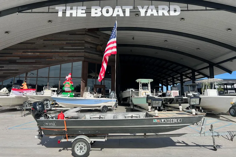 Slide: The Image of 1995 WeldBilt 15 boat on trailer at The Boat Yard dealership. - 0