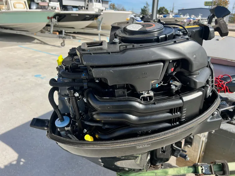 Slide: The Image of Close-up of a 1995 WeldBilt 15 boat engine in a marina. - 4