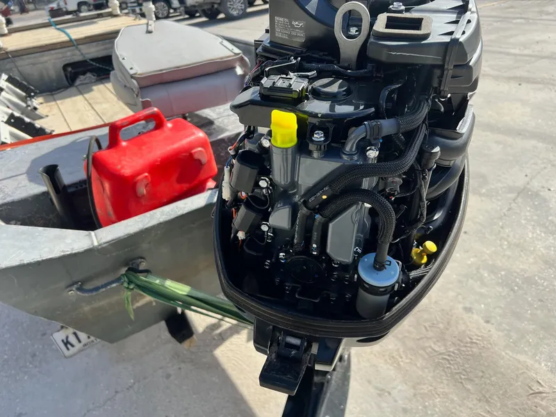 Slide: The Image of Close-up of a 1995 WeldBilt 15 boat engine with a red fuel tank. - 5