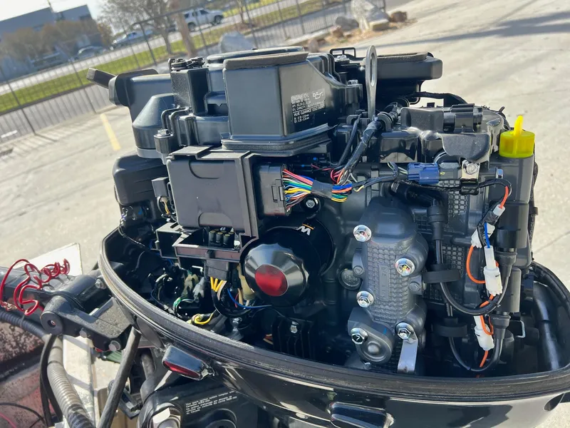 Slide: The Image of Close-up of a 1995 WeldBilt 15 boat engine with visible wiring and components. - 6