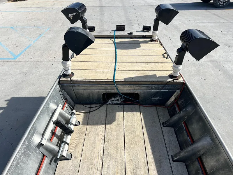 Slide: The Image of 1995 WeldBilt 15 boat with mounted lights and wooden deck. - 8